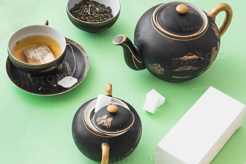 Herbal tea set with white box green paper background