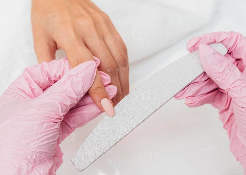 Nail hygiene care beautician wearing gloves close up