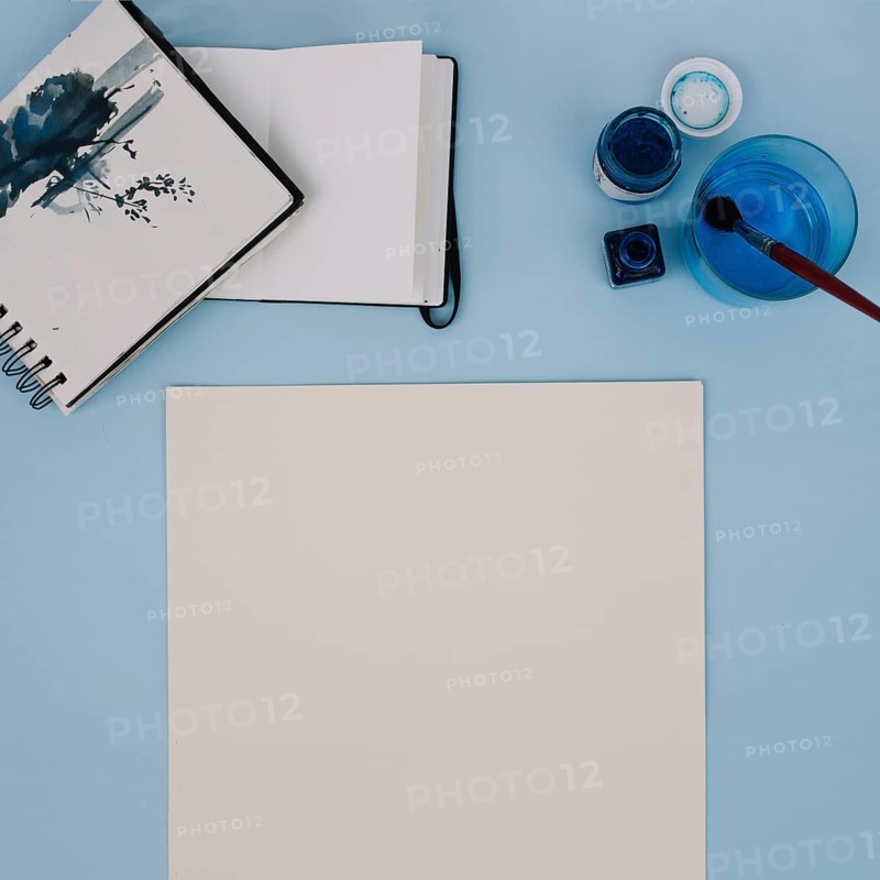 Paint near sketchbooks paper sheet