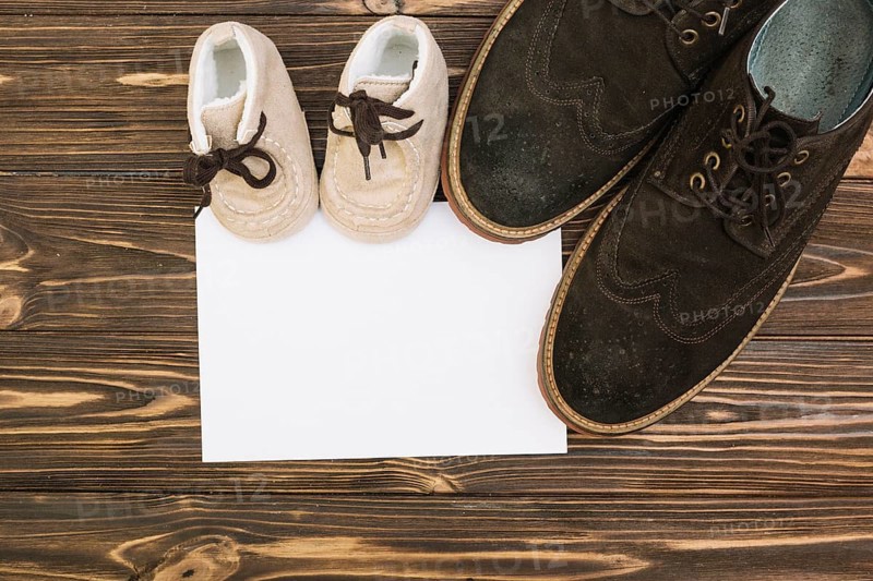 Paper near male child shoes