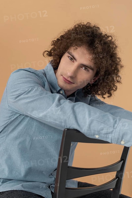 Portrait curly haired young man 14