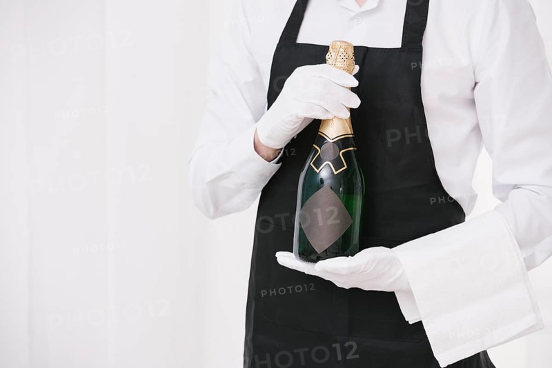 Server holding bottle champagne