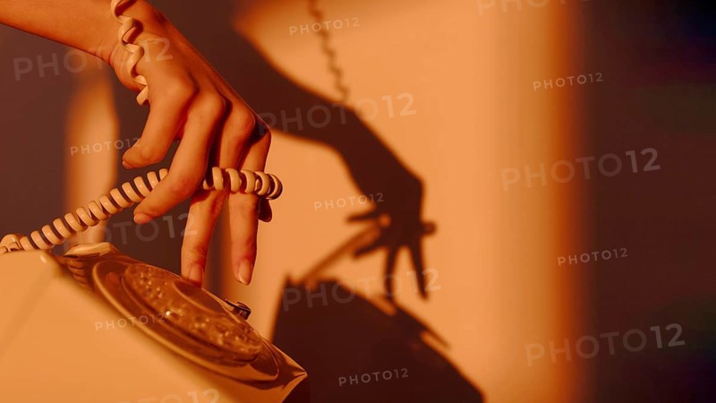 Silhouette woman using telephone