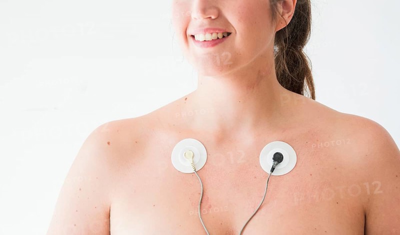Smiling female with electrodes body