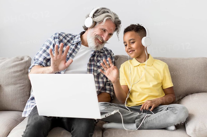 Student teacher waving laptop