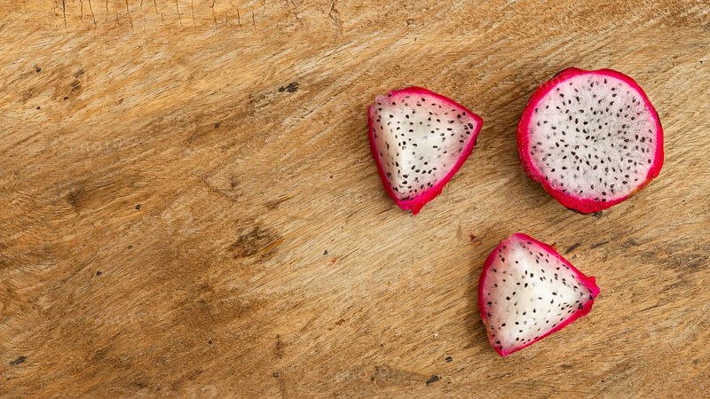 Top view dragon fruit with wooden background