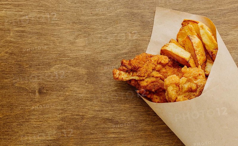 Top view fish chips paper wrap with copy space