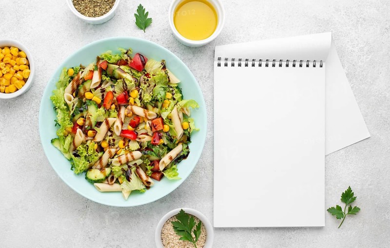 Top view pasta salad with balsamic vinegar blank notebook