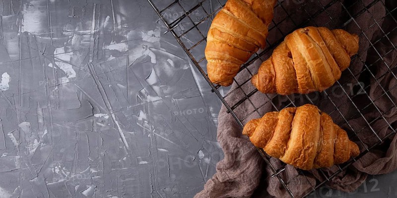 Top view sweet croissants arrangement with copy space