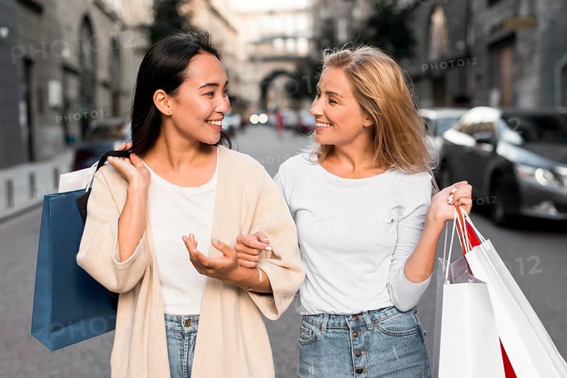 Two women out city going shopping spree