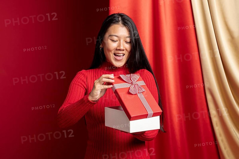 Woman opening gift box chinese new year