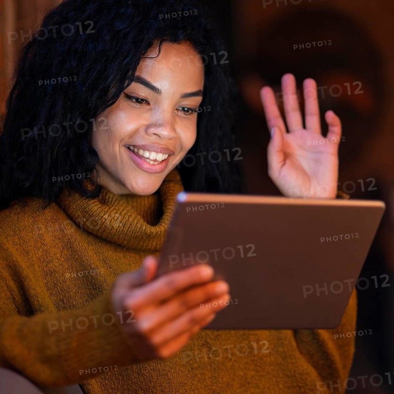 Woman using tablet coffee shop video call
