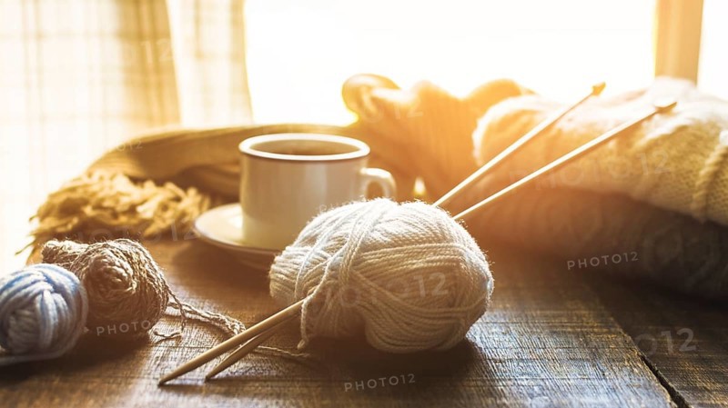 Yarn needles near hot beverage
