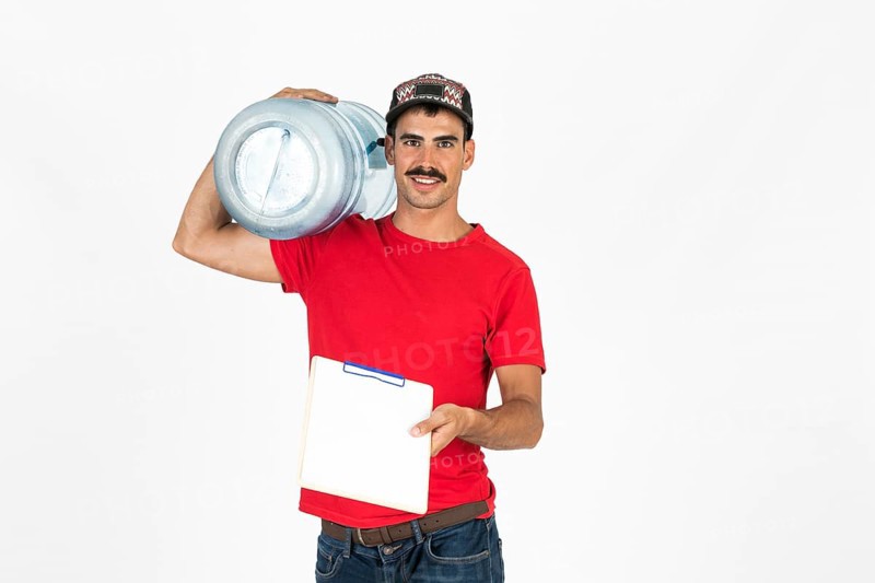 Young deliveryman with water carafe