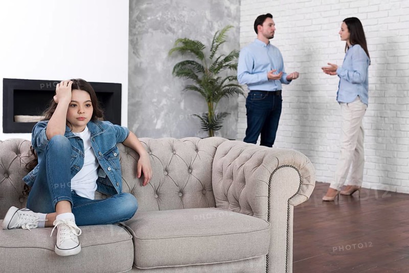 Young girl tired parents arguing