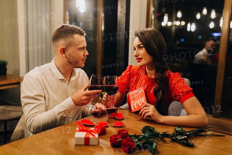 Adorable loving couple with wine cafe