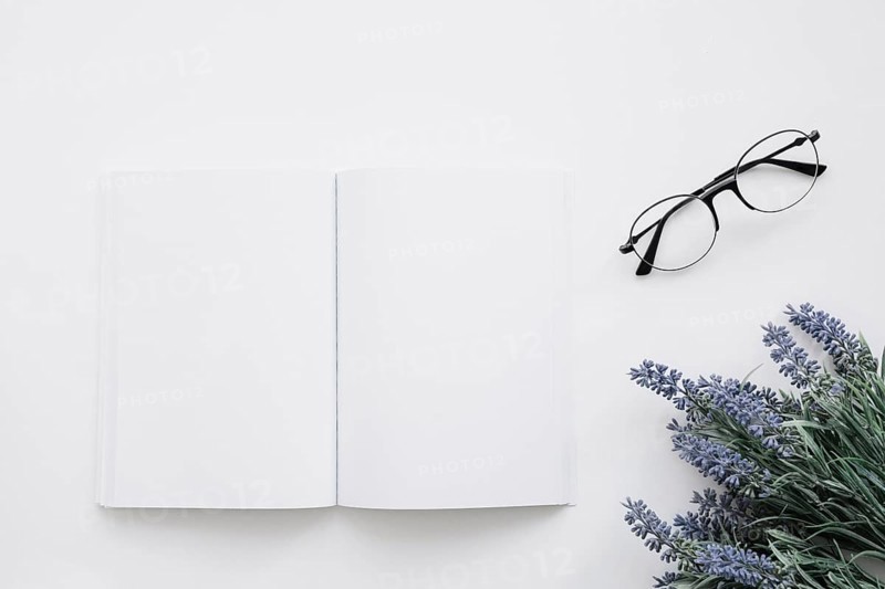 Book cover mockup with glasses flower decoration