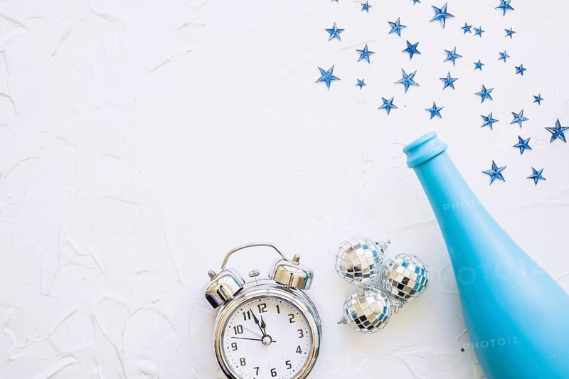 Bottle with clock spangles white table