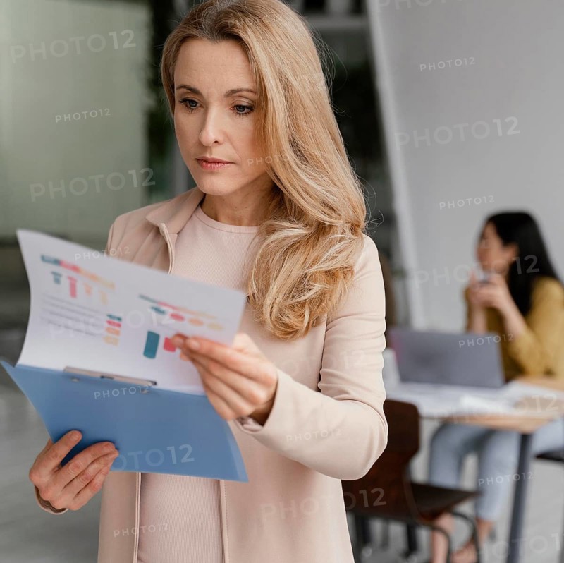 Businesswoman looking through infographics
