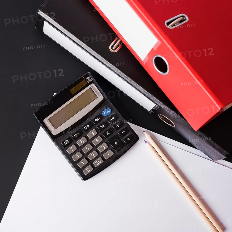 Calculator pencils paper paper files black background