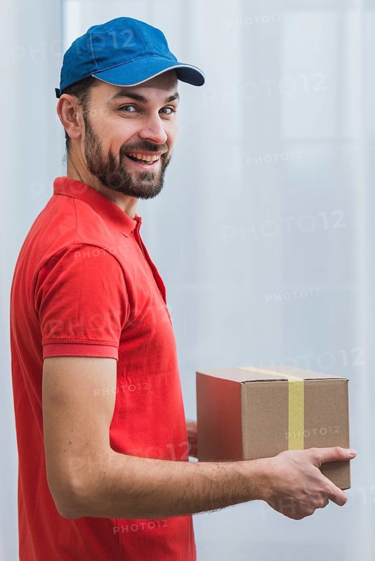 Cheerful courier with sealed parcel