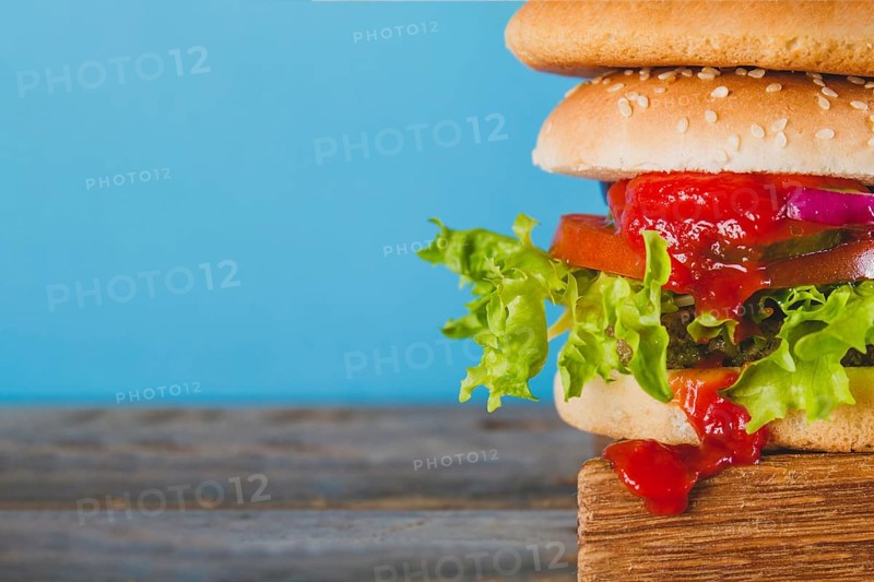 Close up tasty burger with tomato sauce