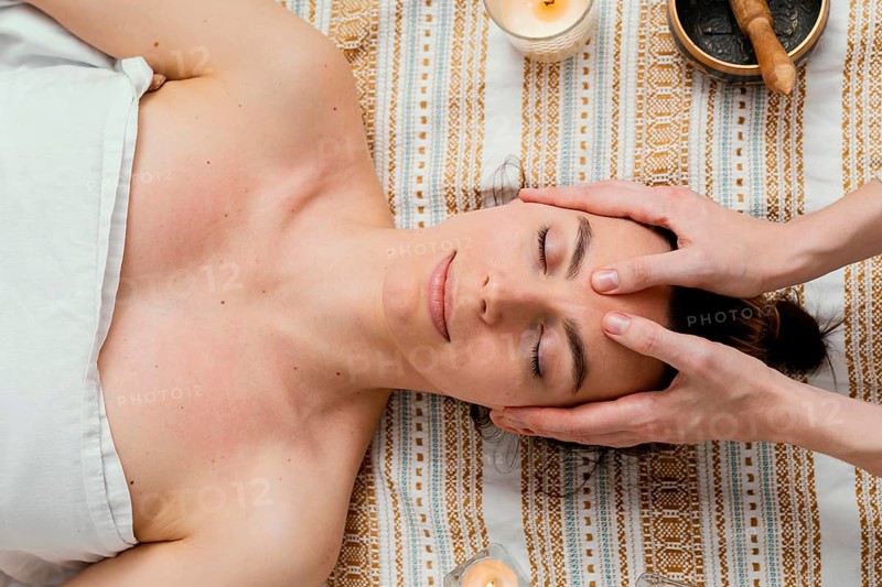 Close up therapist massaging forehead