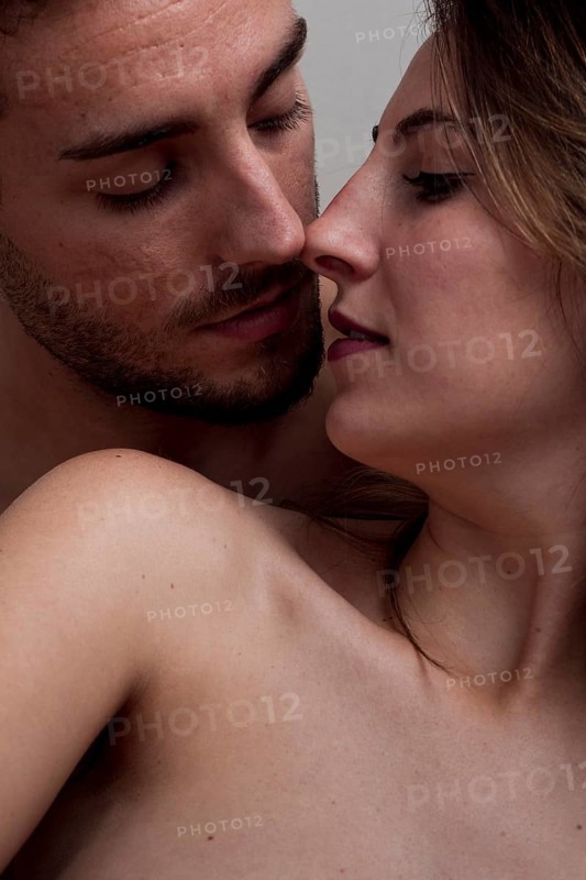 Close up young naked couple kissing