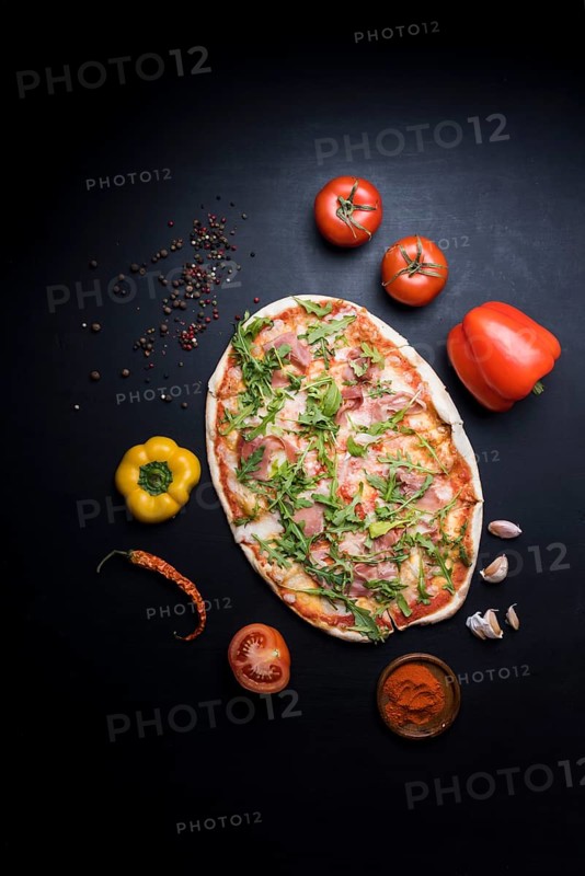 Delicious pizza with ingredients spices wallpaper