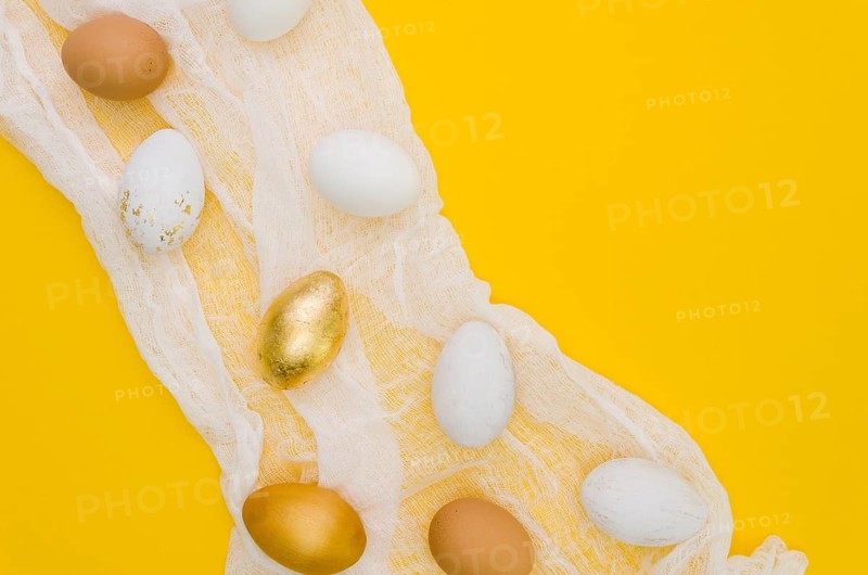 Flat lay eggs easter with gold paint textile
