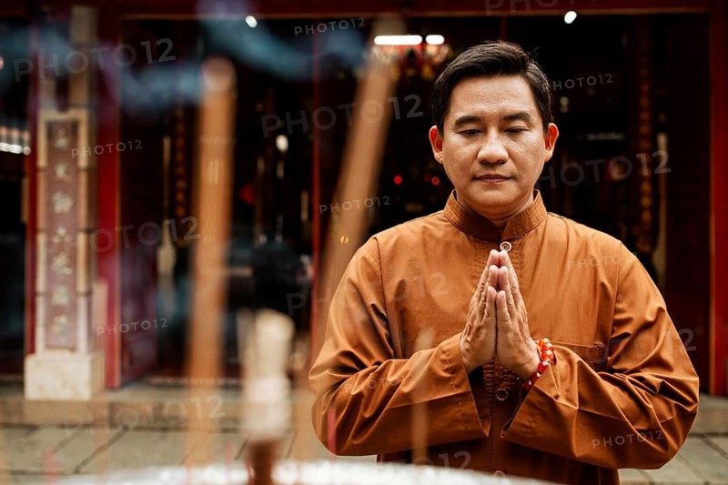 Front view man praying temple with incense