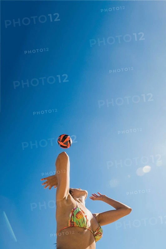 Girl playing volleyball sunny day