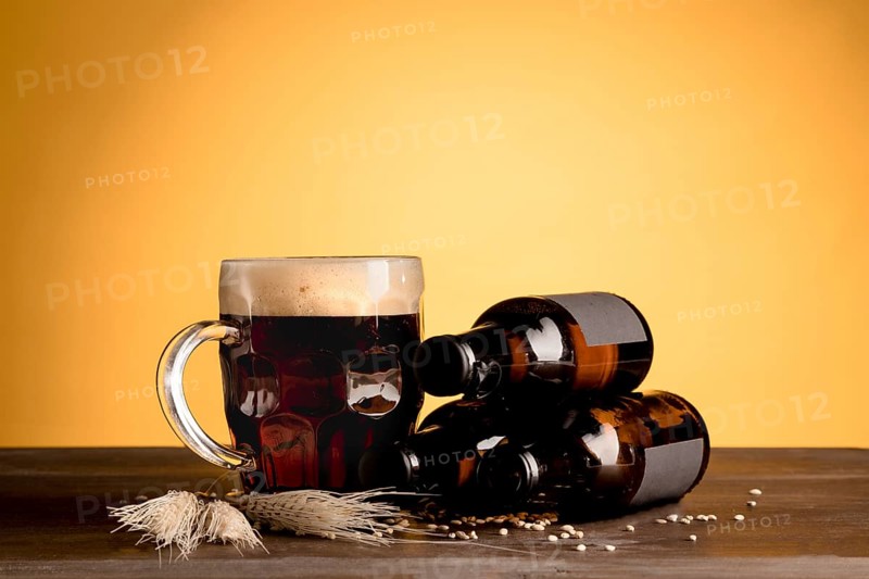 Glass beer with foam bottles beer wooden table