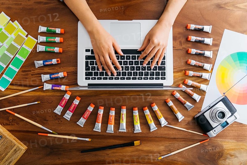 Graphic designer laptop with paint materials