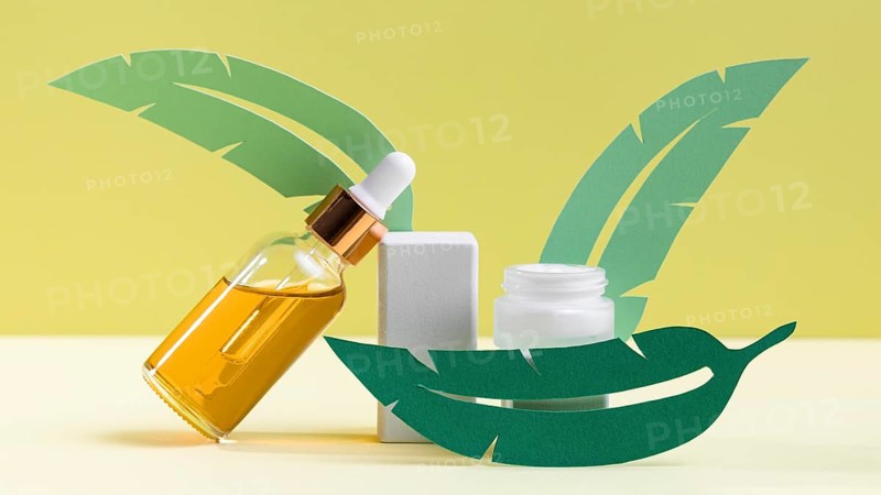 Green leaves with serum bottle