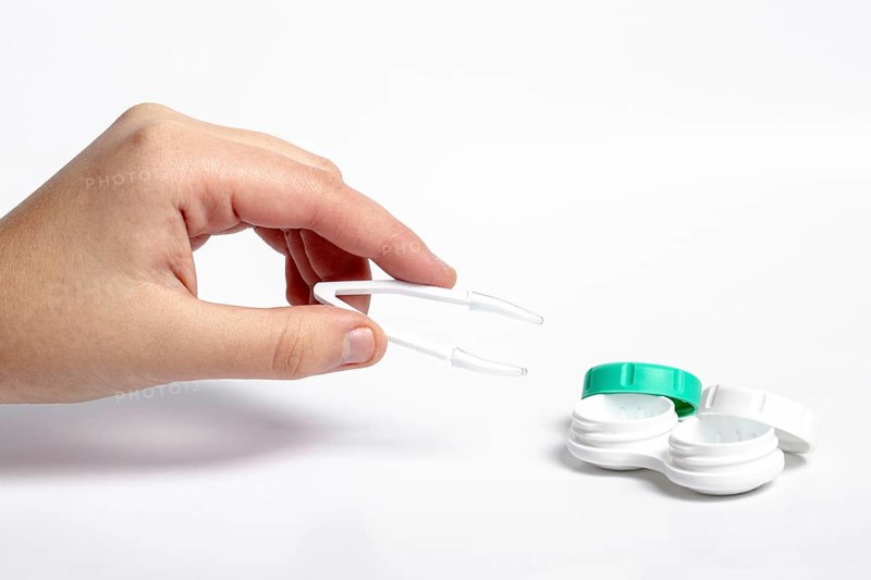 High angle hand holding tweezers contact lenses