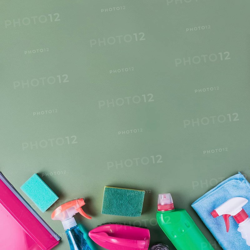 High angle view cleaning supplies green background
