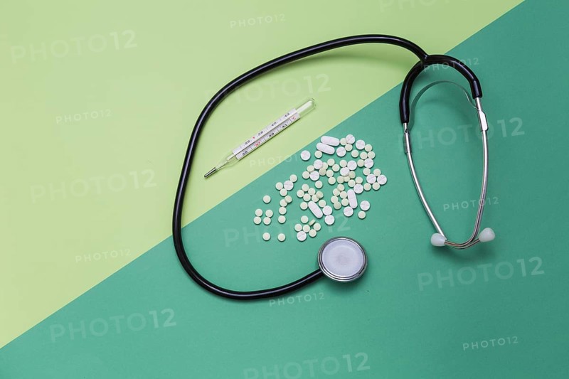 High angle view medicines thermometer stethoscope dual colored background