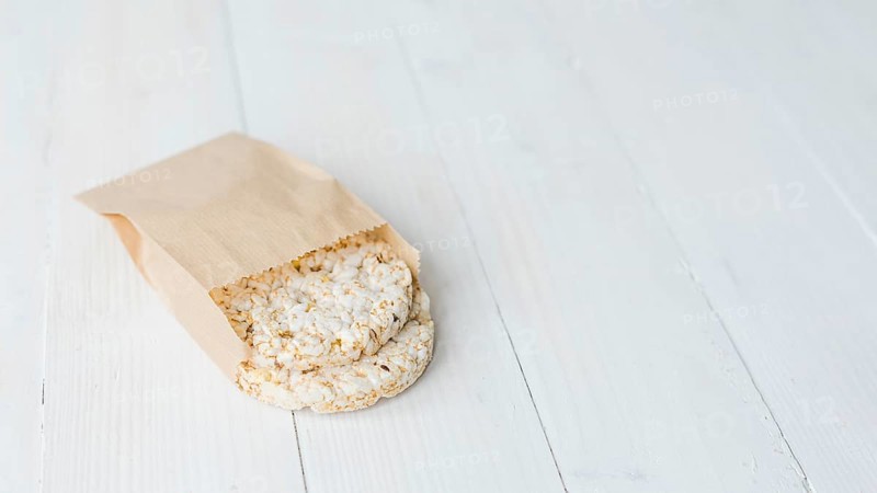 Homemade crispy puffed rice brown paper bag white wooden desk