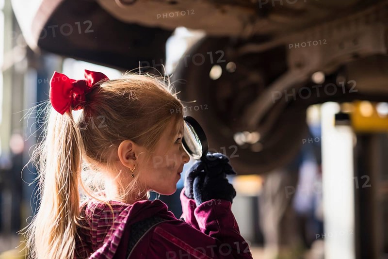 Little girl looking through magnifier