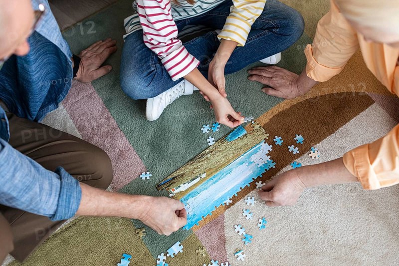 People doing puzzle floor close up