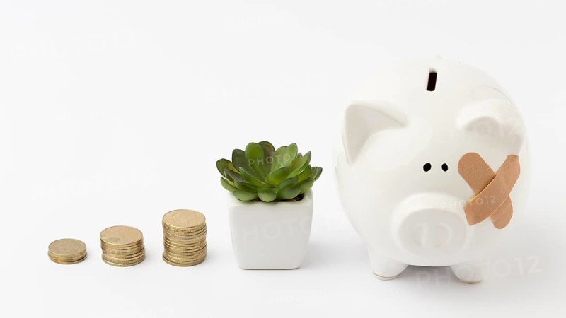 Piles coins broken piggy bank