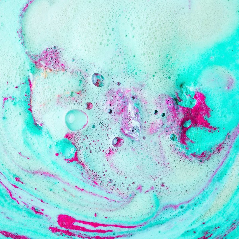 Pink turquoise blue bath bomb dissolving water