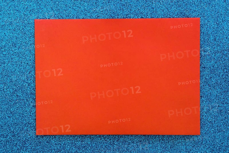 Red cardboard paper blue glitter background