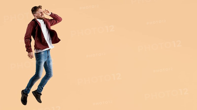 Side view young handsome man jumping