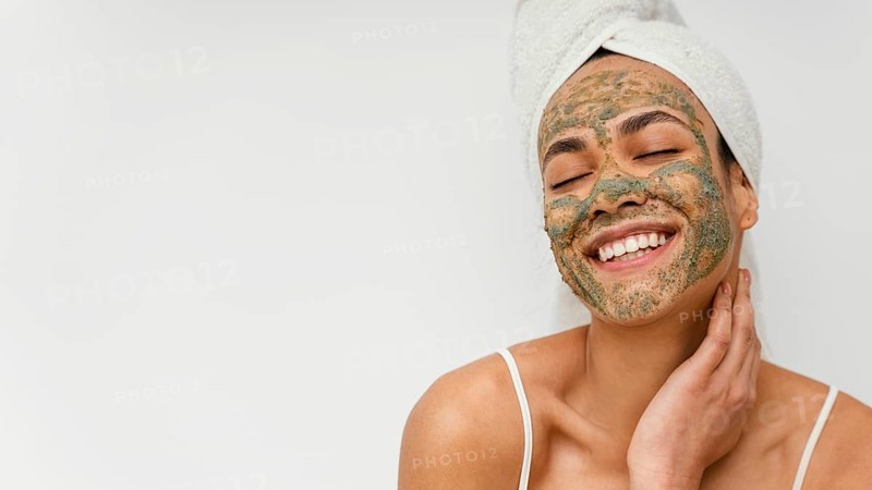 Smiley woman with natural face mask copy space