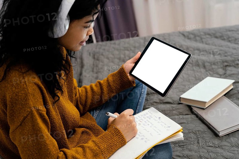 Teenage girl using tablet online school