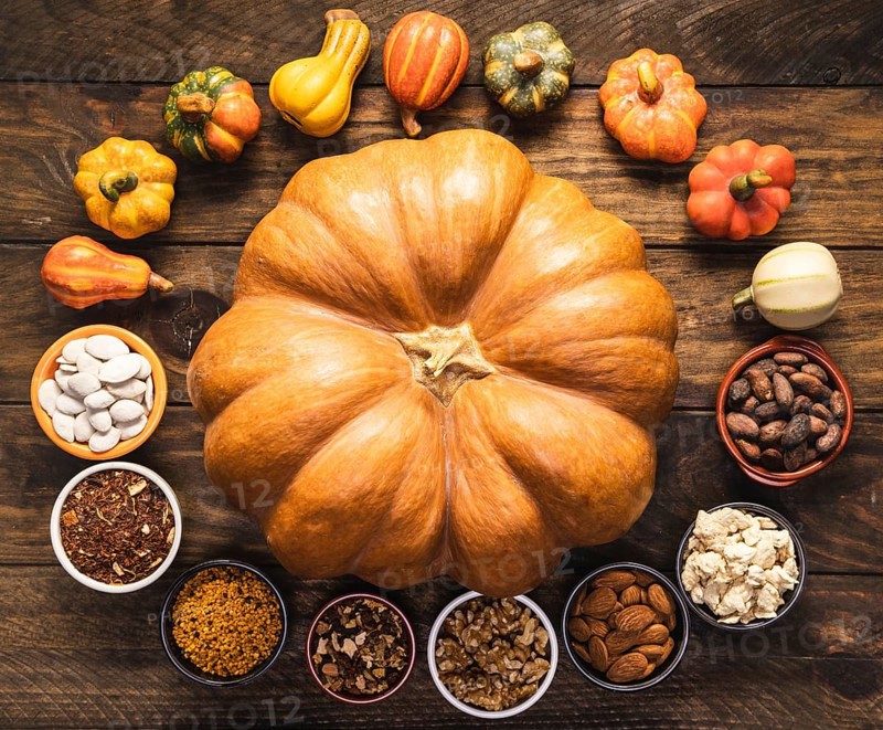 Top view circular food arrangement with big pumpkin
