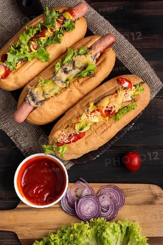 Top view three hot dogs with ketchup onions