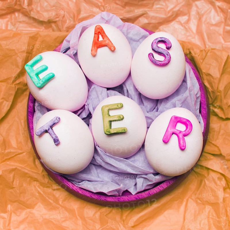 White eggs decorated by letters tray